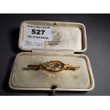 A 9 carat gold bar brooch stone set, approximate weight 1.7 g, boxed. Condition: Brooch is 4.