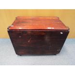 A wooden chest measuring approximately 49 cm x 65 cm x 40 cm, on castors.