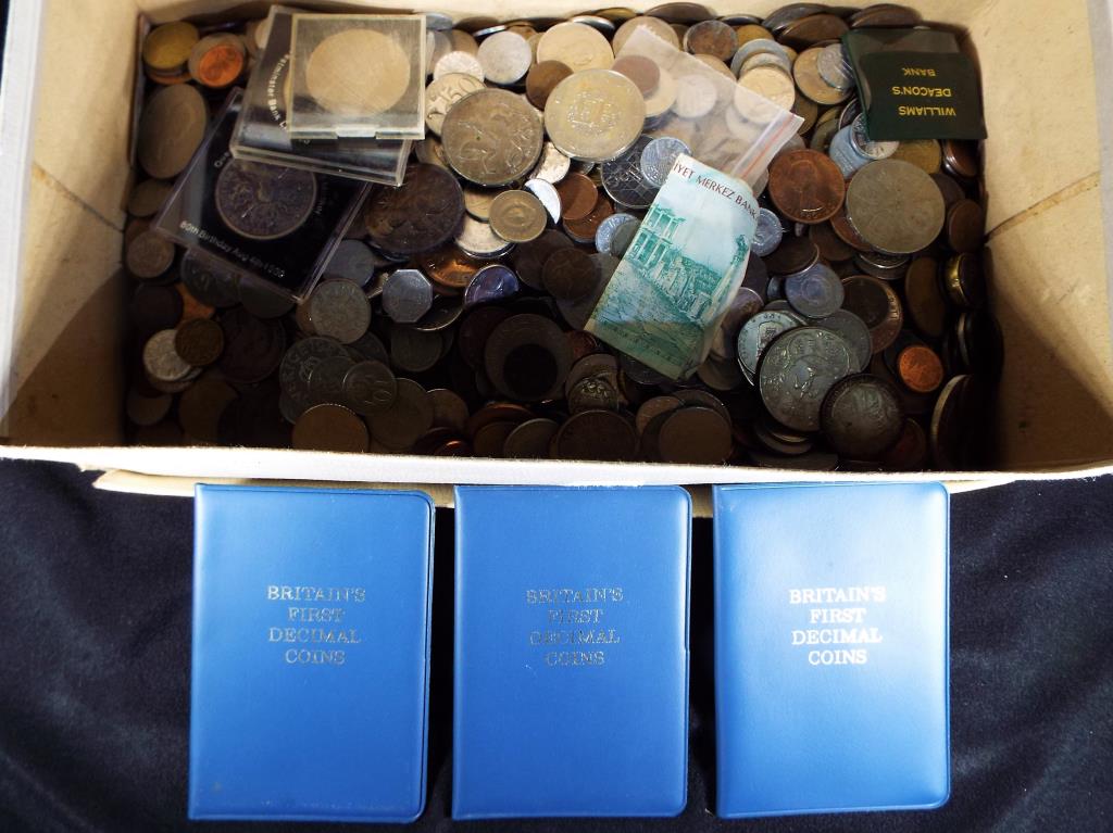 A large quantity of UK and foreign coins to include silver content examples,