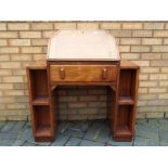 An oak bureau with hinged lid opening to reveal pigeon hole interior over single drawer approximate