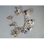 Silver charm bracelet with eight charms.