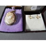 9 ct - a pair of 9 carat gold and pearl earrings both with butterfly backs and a silver cameo