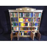 A Del Prado miniature bookcase containing approximately 100 classic novels,