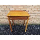 A wooden vintage school desk with metal hinged lid opening to reveal the internal storage.