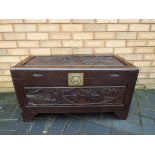 A highly carved Oriental camphor wood chest measuring approximately 46 cm x 88 cm x 43 cm