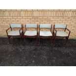 Four vintage dining chairs with upholstered seats and backrest.