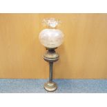 A brass oil lamp with glass shade, approximately 68 cm (h).