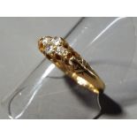 A lady's hallmarked 18 carat yellow gold ring set with four diamonds, size P+, approx weight 3.