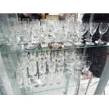 Two shelves of mixed glassware.