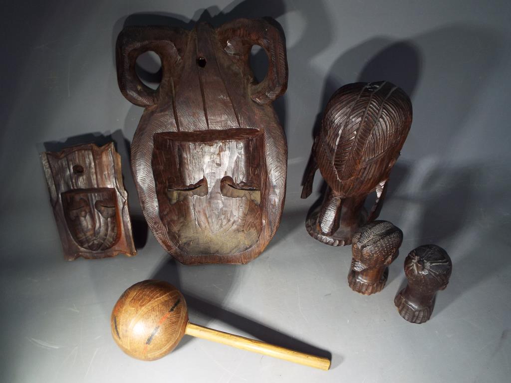 A quantity of hardwood tribal masks and carvings. - Image 2 of 2