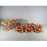 A quantity of Venetian glassware to include nine cranberry liqueur glasses with gilt and enamel