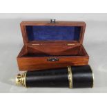 Portable brass and leather telescope in wooden box.