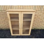 Two door book shelf approximate height 115 cm x 93 cm.