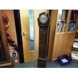 A wooden oak Grandmother clock with key and pendulum.