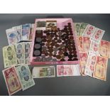 A mixed lot of UK and Worldwide coins and banknotes.