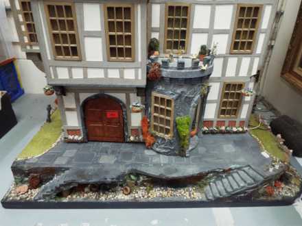 An outstandingly detailed large Tudor style doll's house in naturalistic garden setting, - Image 2 of 6