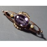 A 9 carat gold bar brooch set with pearls and amethyst, approximate weight 2.6 grams.