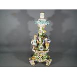A detailed Meissen style European centrepiece (lacking basket) decorated with flowers,