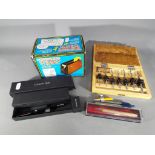 A mixed lot to include pens, a vintage Cordless Electric Mini Tape-O-Matic (boxed),