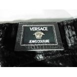 Designer clothing - a pair of black velvet trousers marked Versace Jeans Couture with all buttons