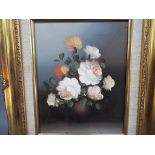 A framed oil on canvas still life of flowers, approximately 24 cm x 19 cm.