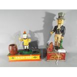 Two cast iron money banks comprising Uncle Sam and Trick Dog.