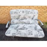 A modern metal framed two seater sofa co