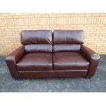 A modern two seater brown leather sofa (