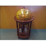 A drinks cabinet in the form of a terrestrial globe with decanter and glassware,