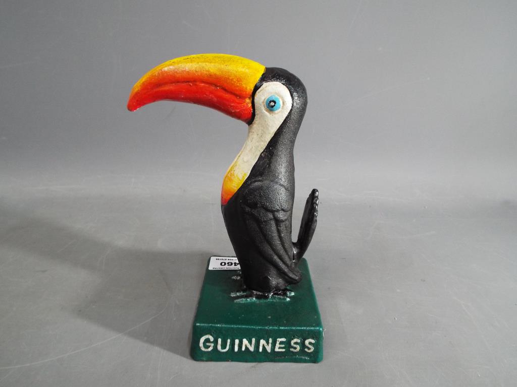 A cast metal sign in the style of a Guinness Toucan