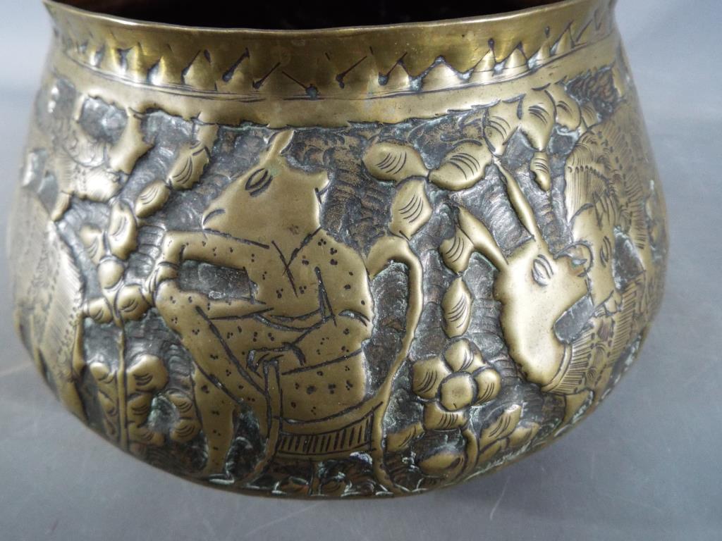 A middle eastern gilt bowl with repoussé decoration depicting fauna and mythical creatures, - Image 3 of 8