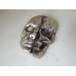 A silver depiction of a Skull, 8 ounces stamped.