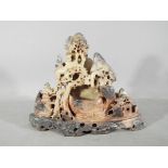 A Chinese soapstone carving of a mountainous landscape scene,