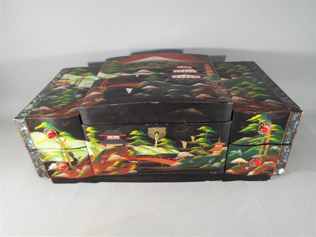 A Japanese lacquered, musical jewellery box with hand painted landscape decoration, - Image 2 of 2