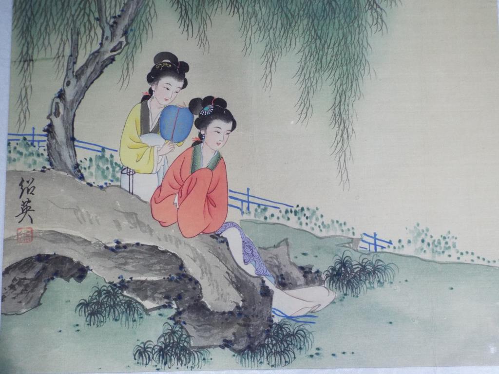 An ink and watercolour painting depicting two ladies in a landscape setting, signed to the left.