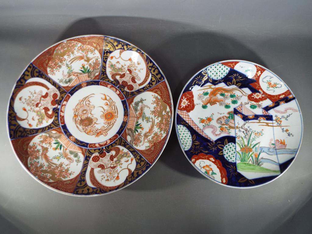 Two Japanese Imari chargers decorated with birds and floral motifs,