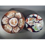 Two Japanese Imari chargers decorated with birds and floral motifs,