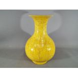 A large Chinese yellow glazed baluster vase with everted rim,