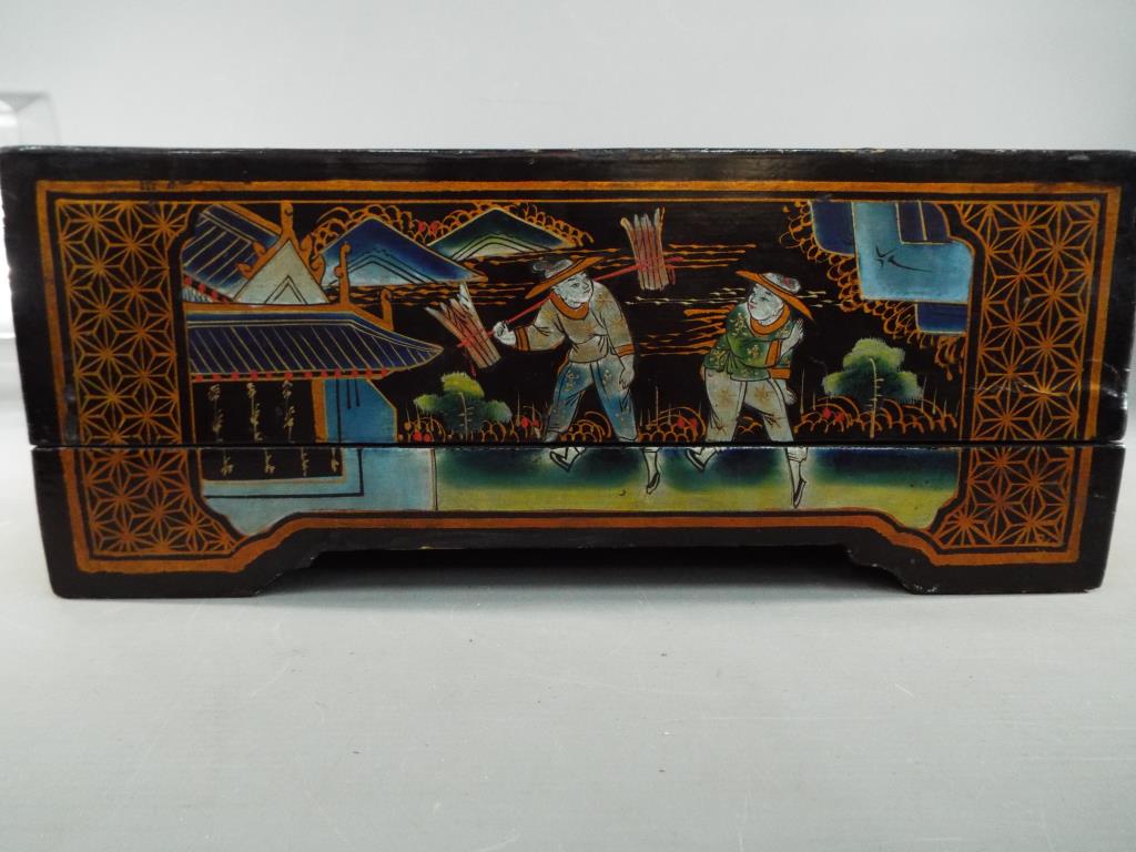 A mid 20th century - A large lacquered box and detachable cover having hand painted figure scene