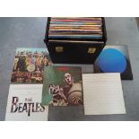 A carry case containing a quantity of 33 RPM vinyl records to include The Beatles, Pink Floyd,