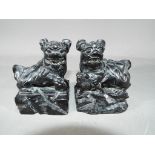 A pair of Chinese, black soapstone carvings depicting Imperial Guardian or Buddhist Lions.