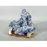 A Chinese, lapis lazuli figural group depicting a boy seated atop a buffalo,