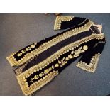 A black velvet kaftan with gold coloured embroidered decoration, approximately 147 cm length,