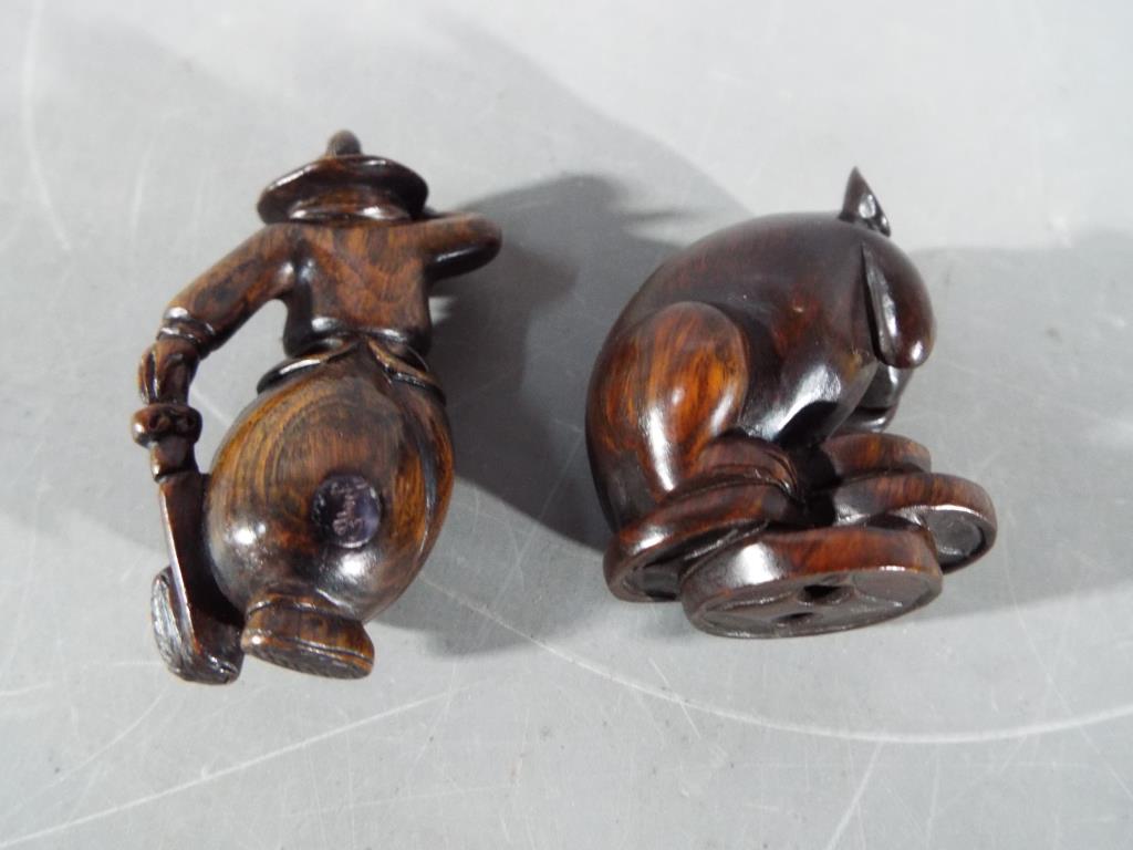 A vintage Japanese dark wood Netsuke depicting a large mouse or rat carrying its catch, - Image 2 of 5
