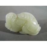 A Chinese fine celadon jade carving, possibly Shan Cai Tong Zi, the boy of wealth,