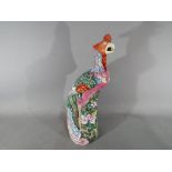 An 18th Chinese famille rose ceramic figurine depicting a Fenghuang (phoenix),