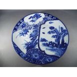 A Meiji period blue and white Arita charger painted with design of overlapping fans decorated with