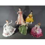 Five ceramic lady figurines,
