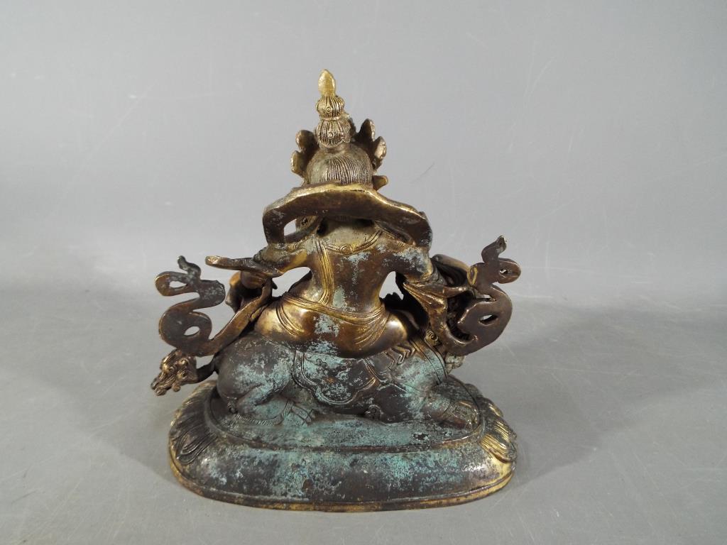 Buddha - An 18th / 19th century Chinese Tibetan gilt bronze Buddhist figure depicting Jambhala - Image 4 of 5