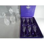 A boxed set of Edinburgh Crystal wine glasses and three decanters to include a Waterford Crystal
